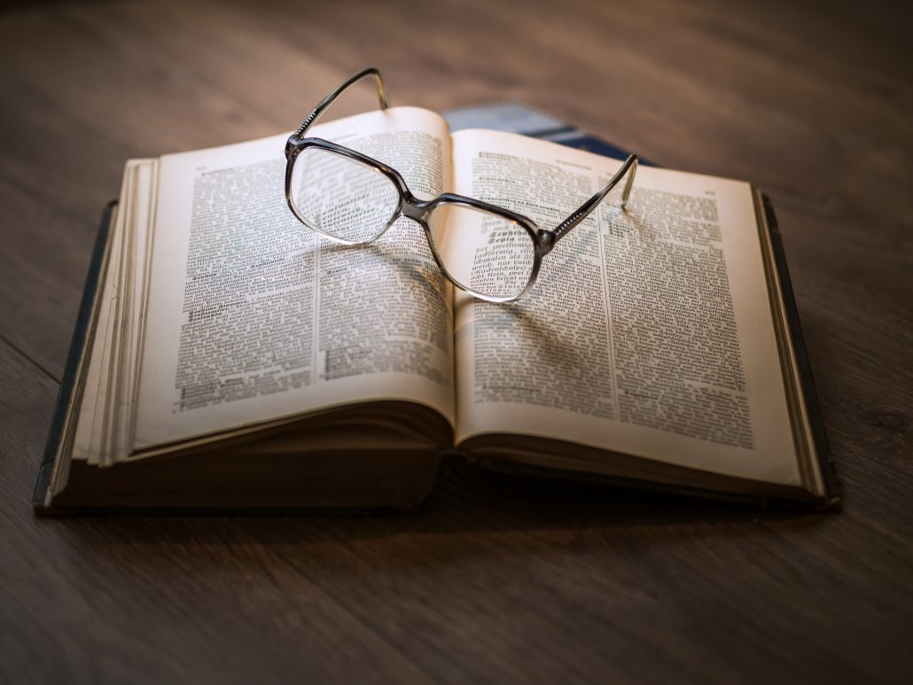 a book and glasses for massage research